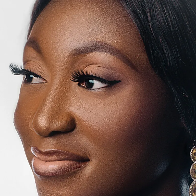 Model wearing lash extensions applied with professional adhesive