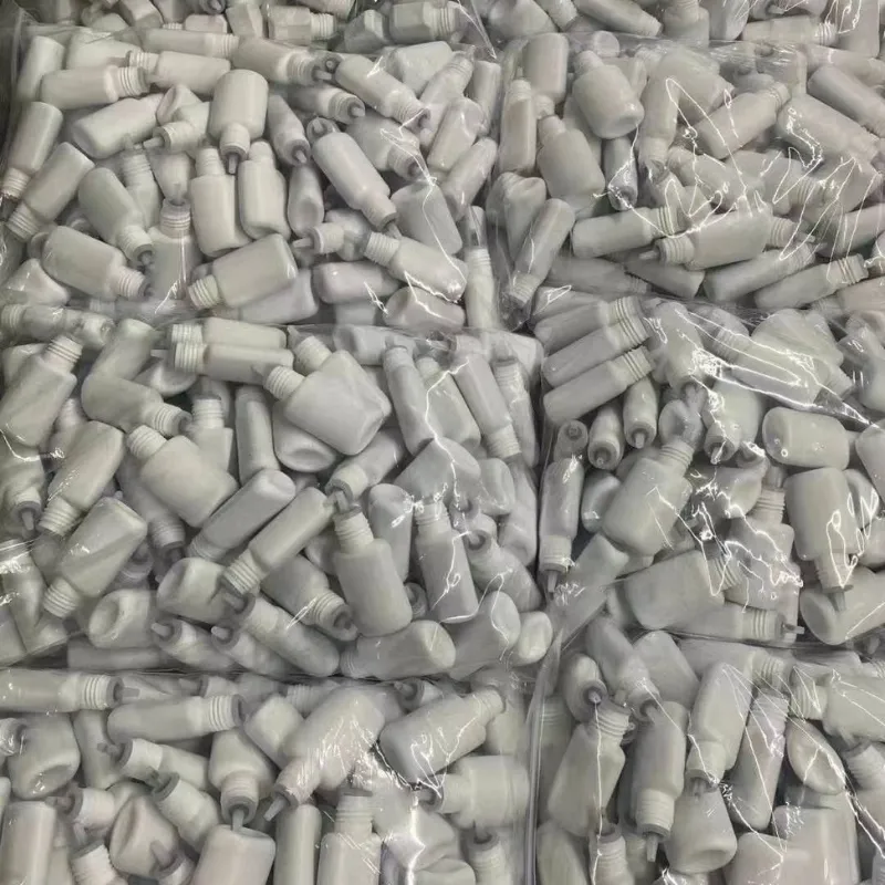 Bulk white lash glue bottles packed in clear bags before labeling