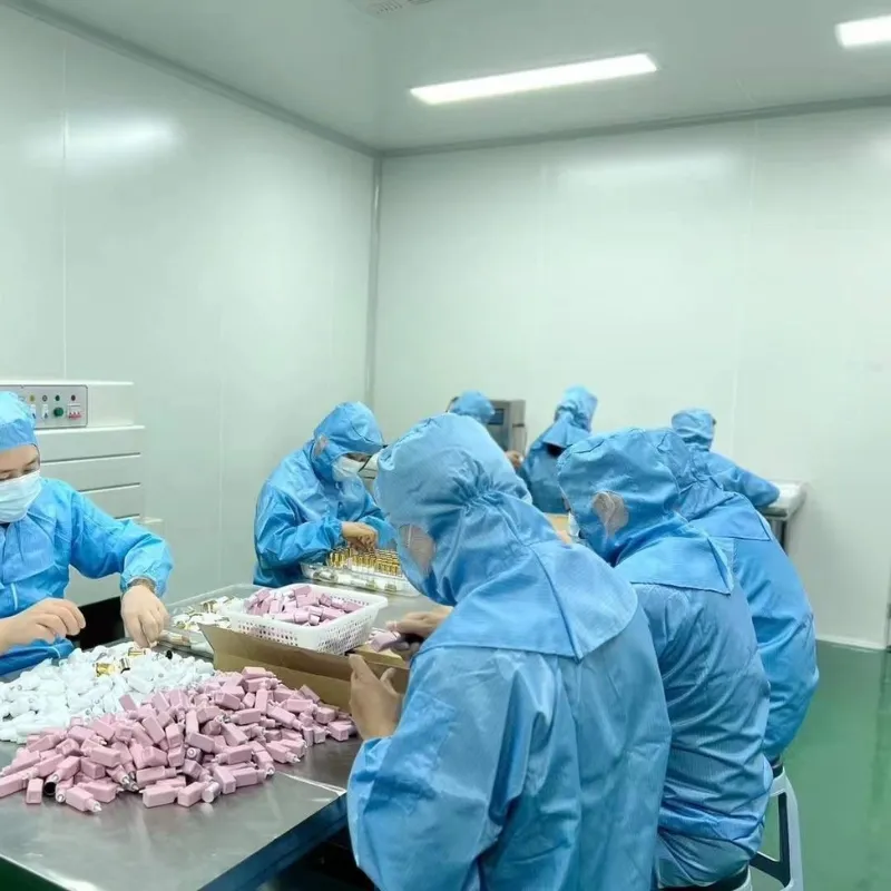Cleanroom technicians packing lash glue components at a production table