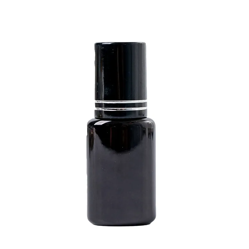 Black lash glue bottle with a black cap on a plain background